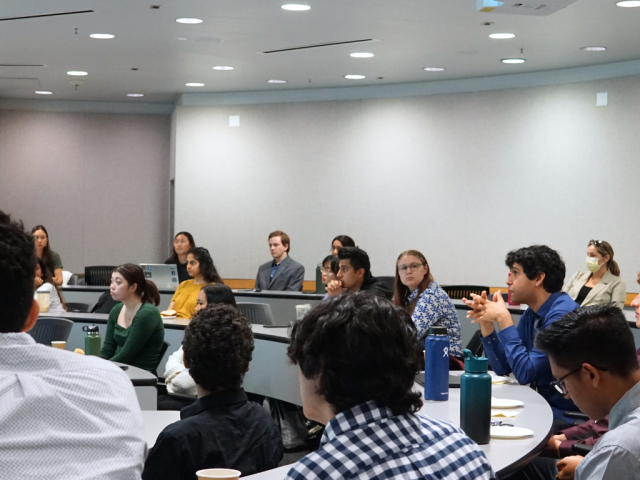 Scholars attentively providing feedback at the 2023 Research Symposium